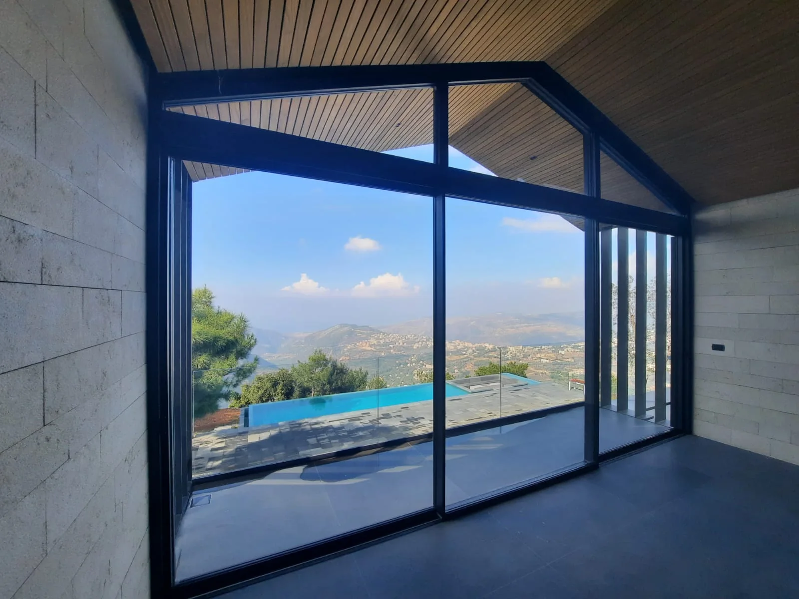 Villa DBA, floor-to-ceiling glazing over an infinity pool and the valley