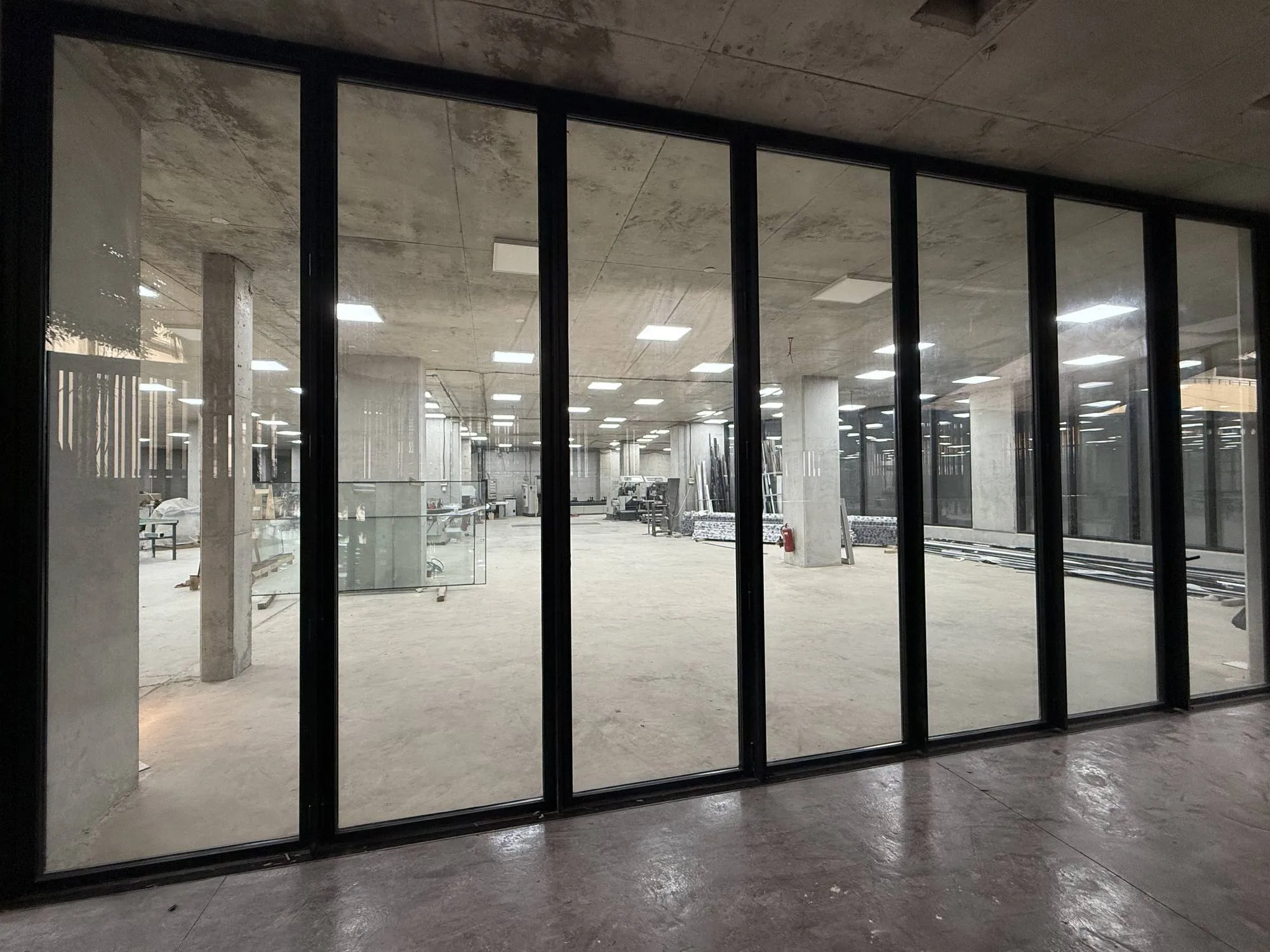 Black-framed glazing at the AG Building, looking into the workshop